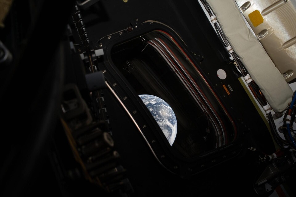 Reid Wiseman's photo of Earth from one of Orion's four main windows after completing the lunar orbit insertion burn.